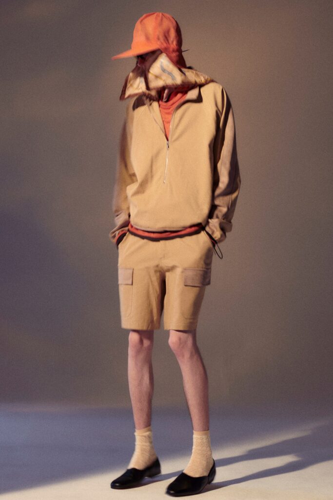 A relaxed beige jacket with a zippered front paired with matching shorts.