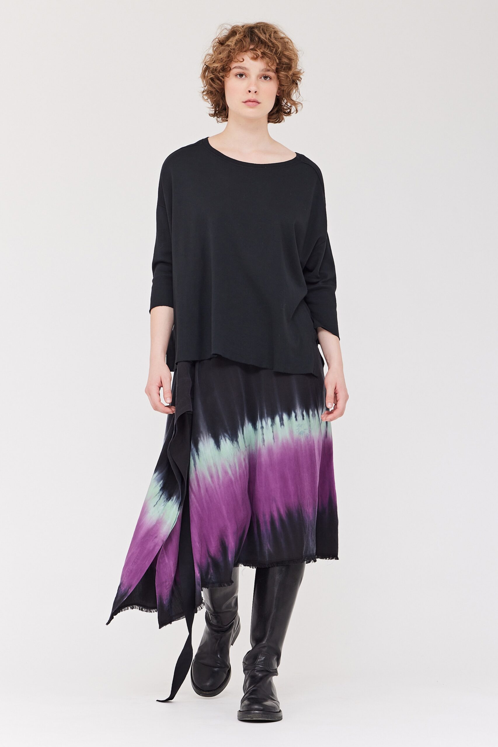 A relaxed black long-sleeve top paired with a tiered skirt featuring purple tie-dye accents.