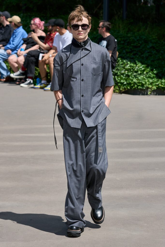 A relaxed gray striped short-sleeve shirt paired with matching pants featuring a buttoned design.