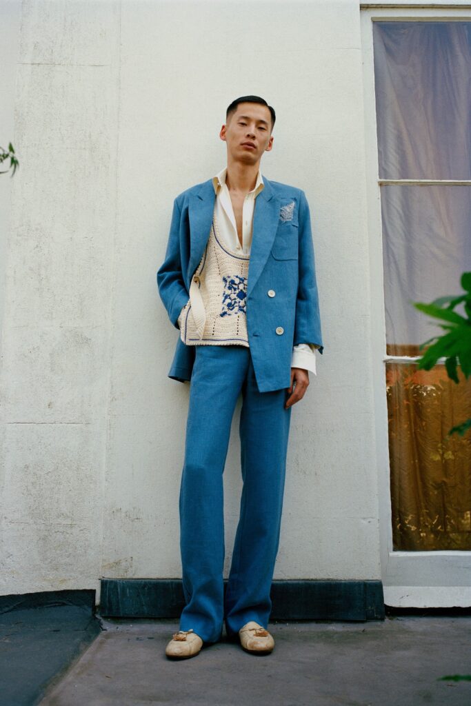 A tailored blue suit featuring a long-sleeve collared shirt and a buttoned vest.