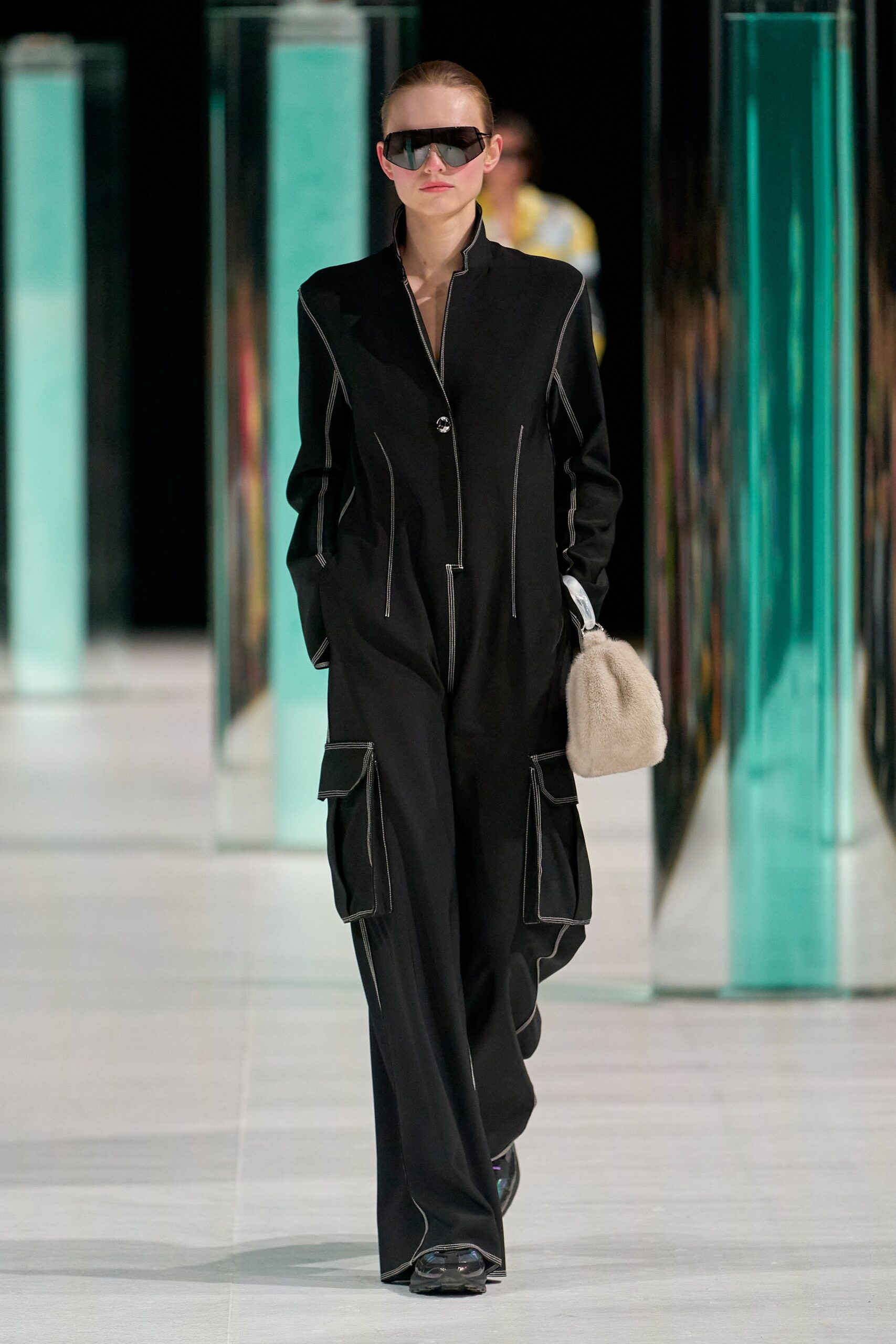 A fitted black cotton jumpsuit with long sleeves and a zippered front.
