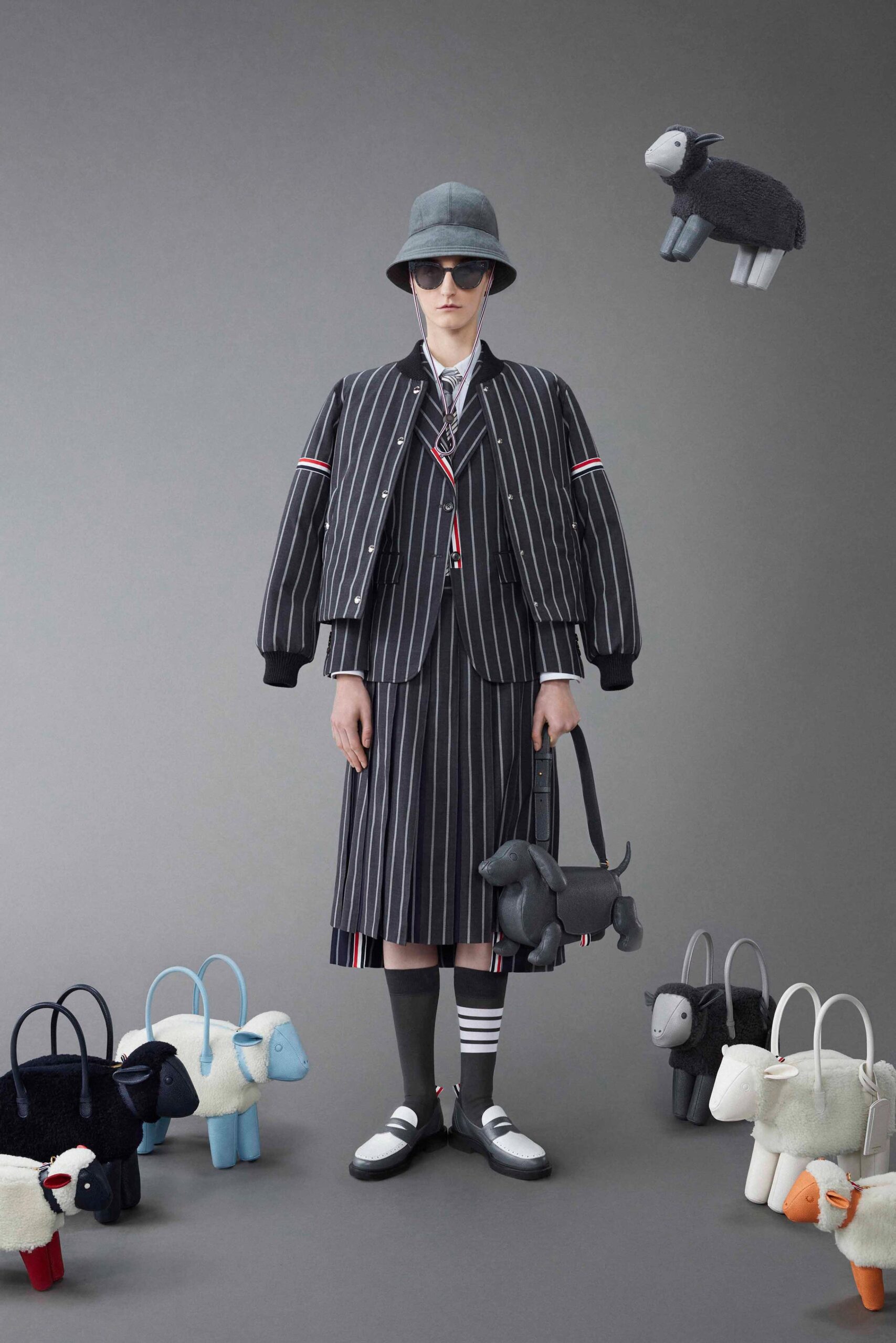 A relaxed black and white striped jacket paired with a pleated skirt for a stylish look.