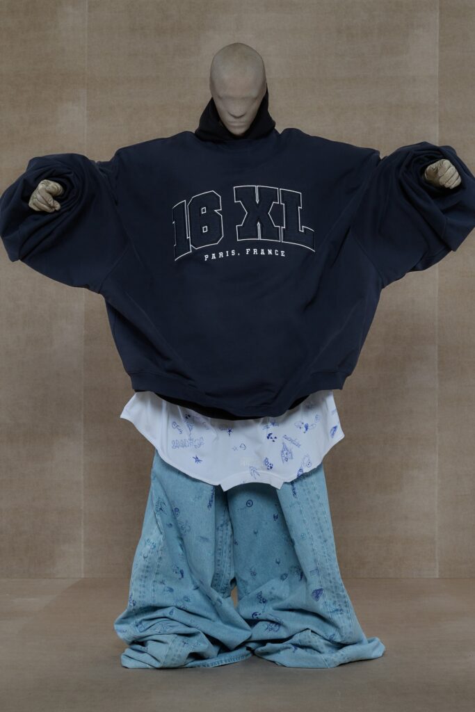 An oversized blue hoodie with long sleeves paired with printed blue pants.