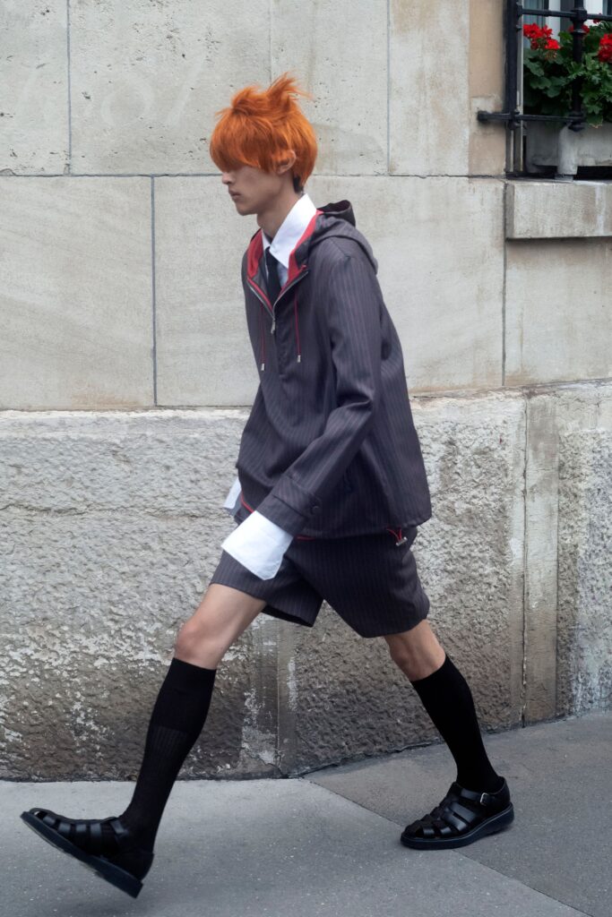 A relaxed gray striped jacket with a collared neckline paired with matching shorts.