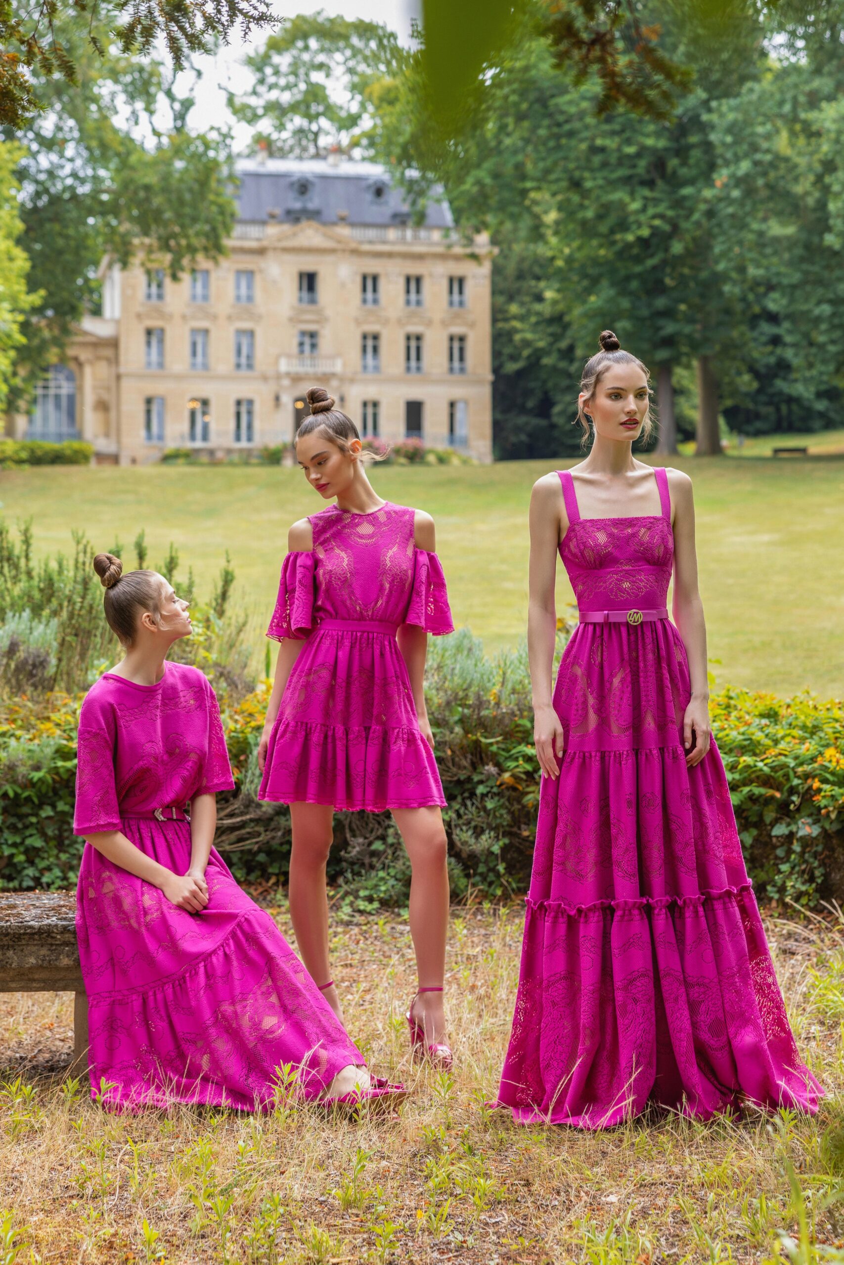 A fitted pink cotton sleeveless dress with a V-neckline and tiered design.