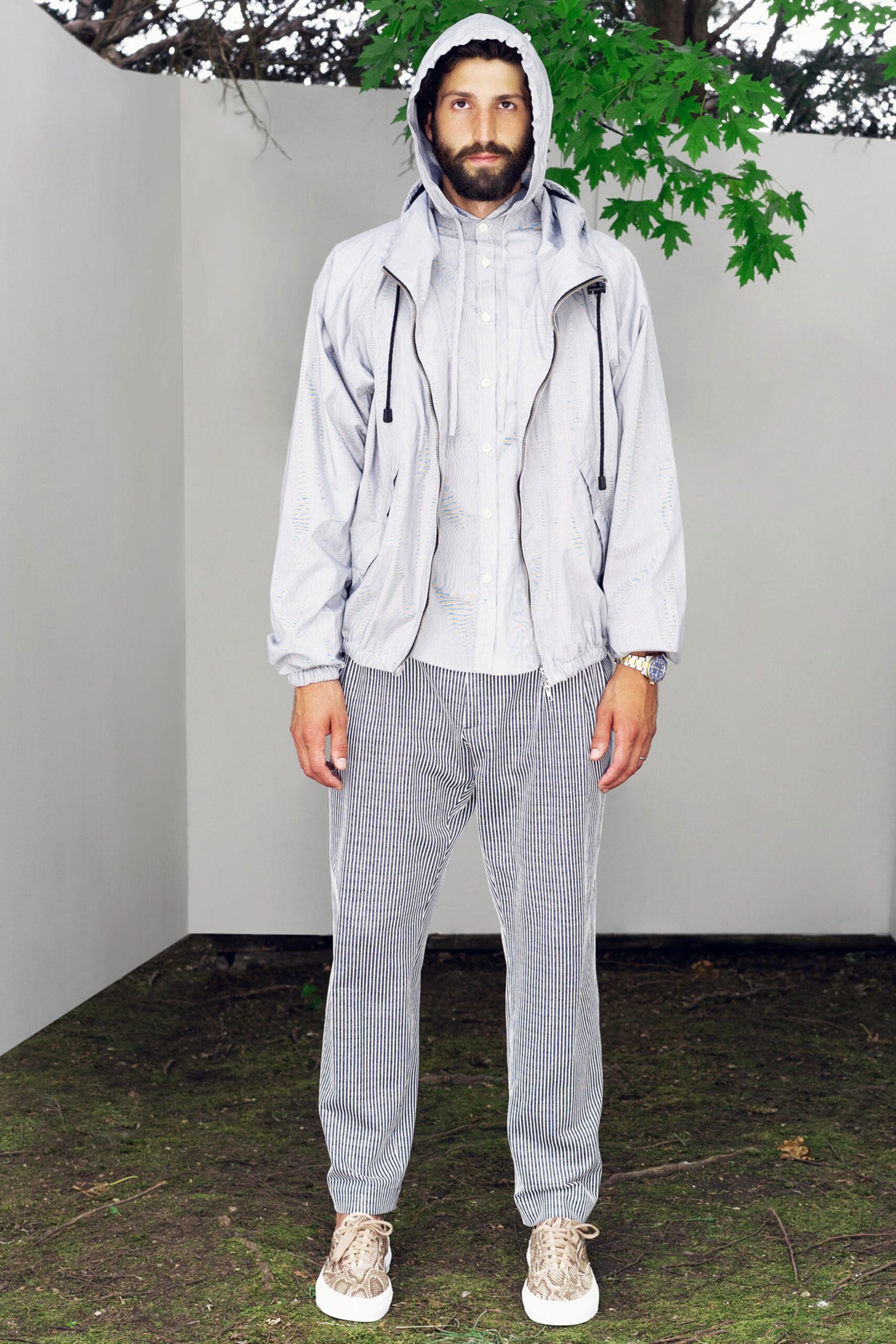 A relaxed gray jacket with a collared shirt and striped pants for a casual look.