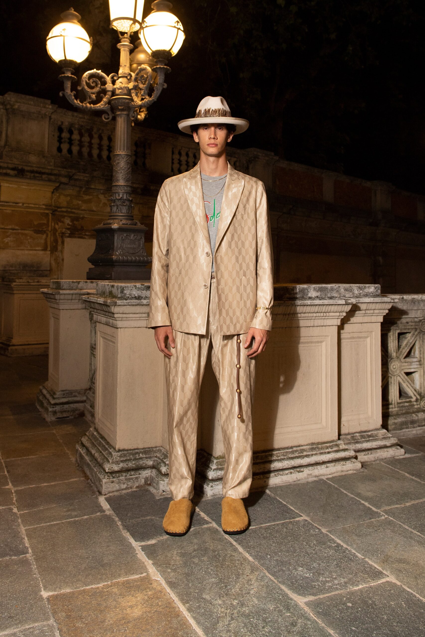 A relaxed beige suit with long sleeves, a collared shirt, and embroidered details.