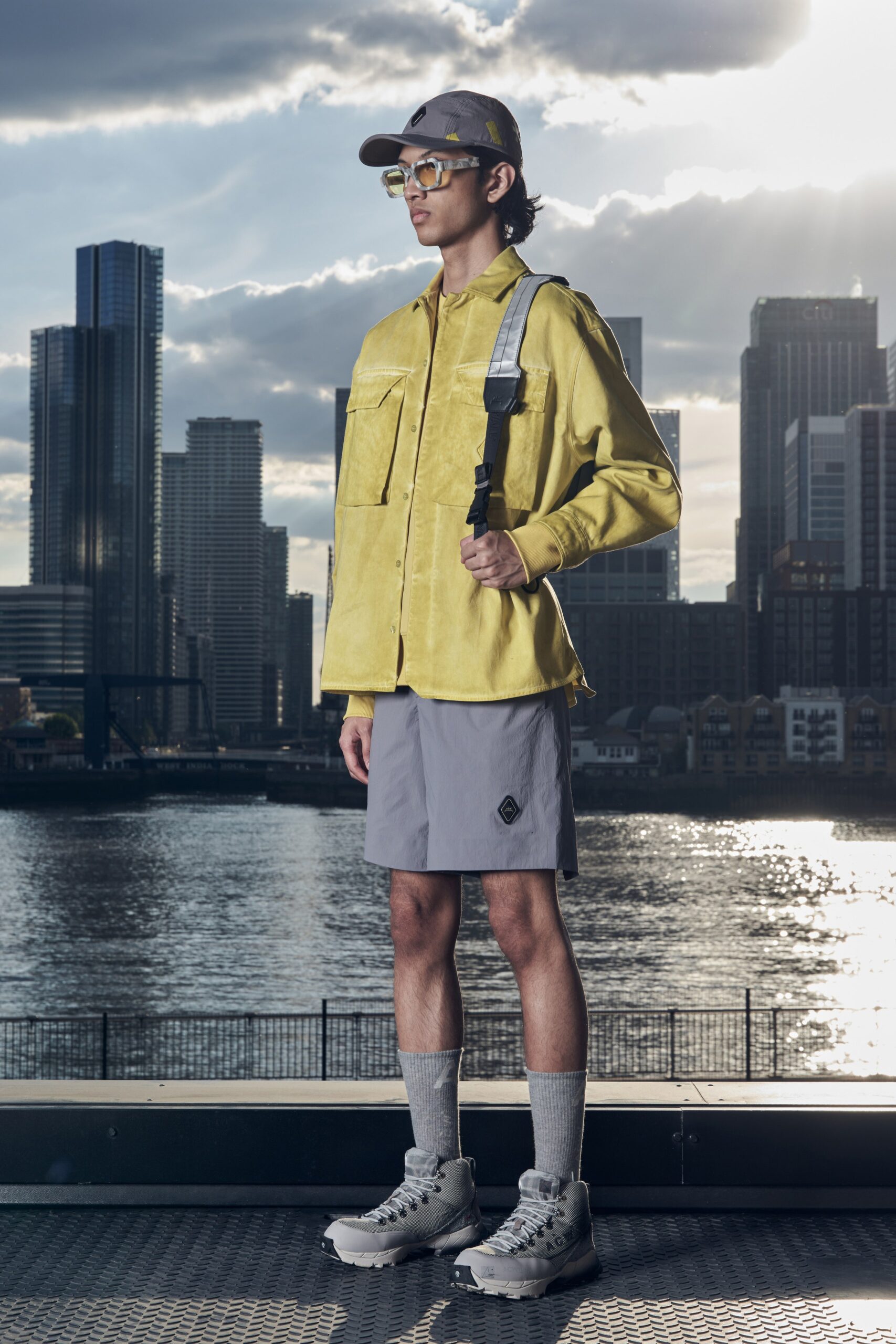 A relaxed yellow suede long-sleeve jacket paired with gray cotton shorts.