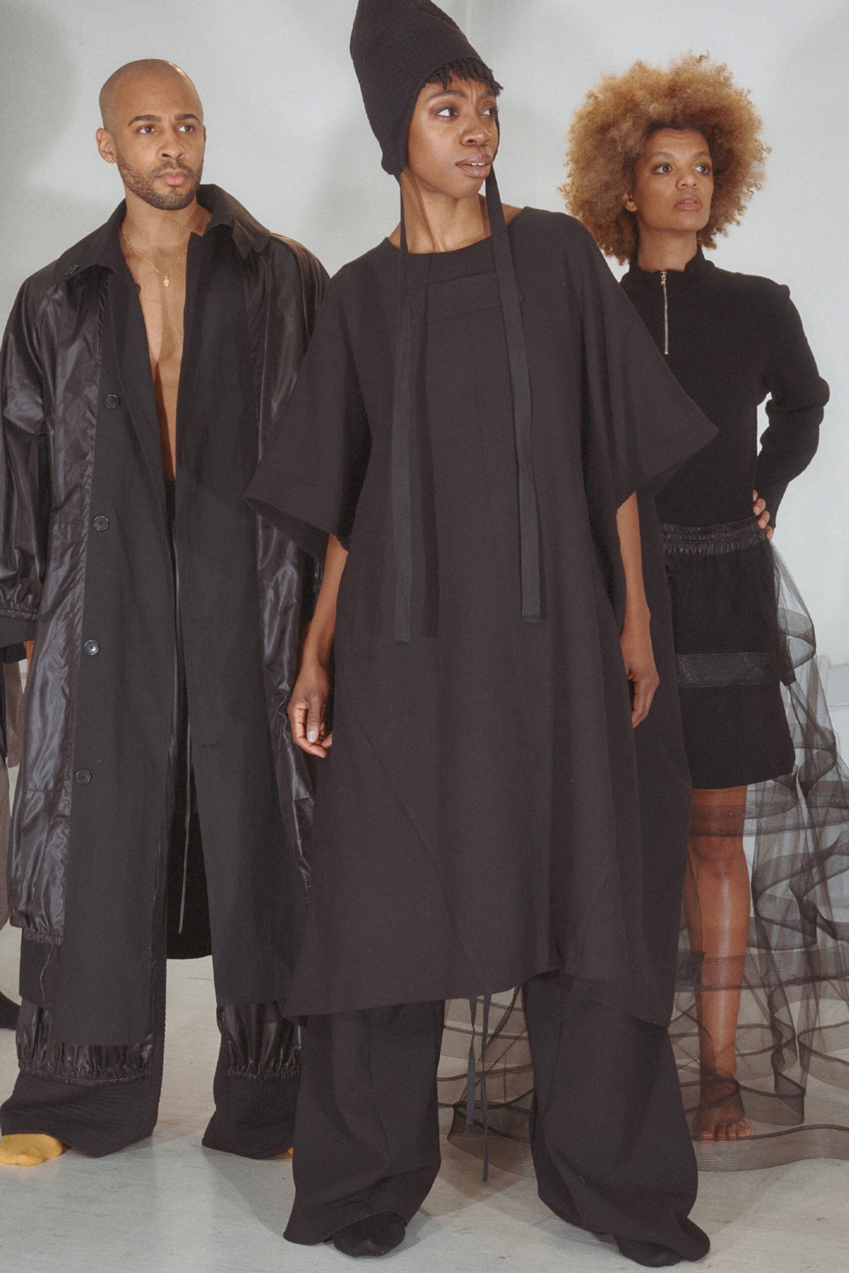 This relaxed sleeveless dress in black features an asymmetric silhouette that creates a dynamic visual flow. The high-neck construction adds a touch of sophistication, while the overall shape allows for effortless movement and an avant-garde appeal.