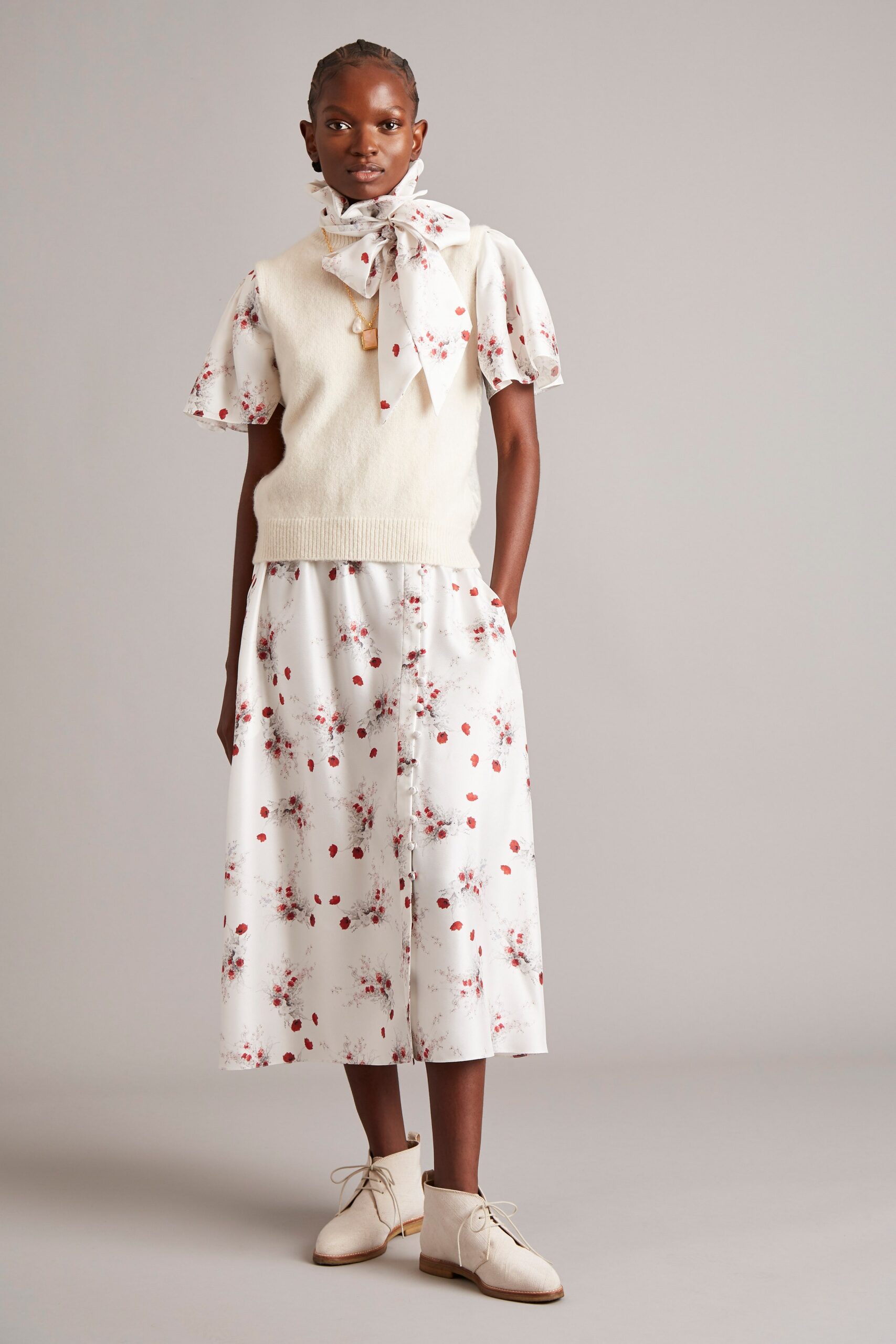 white cotton top with beige vest