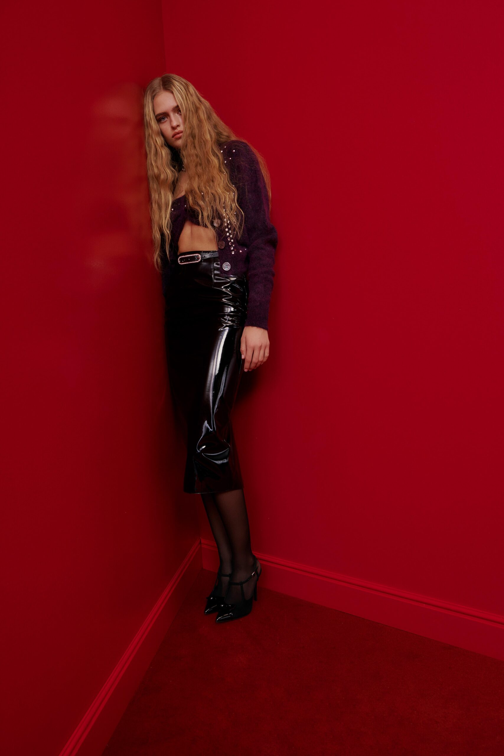 purple fitted top with black vinyl skirt