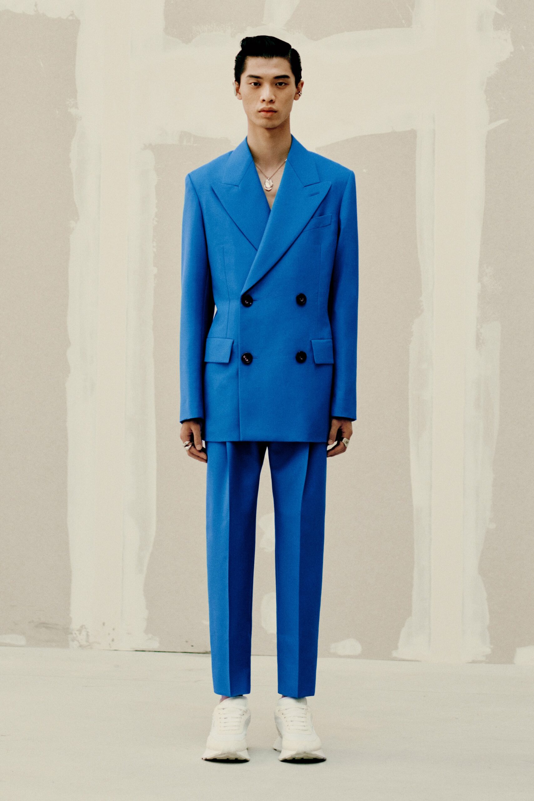 blue tailored suit with white shoes