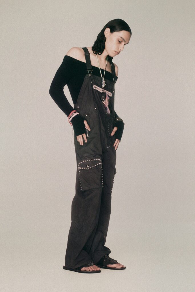 Relaxed black denim overalls with an off-shoulder design and embroidered details.