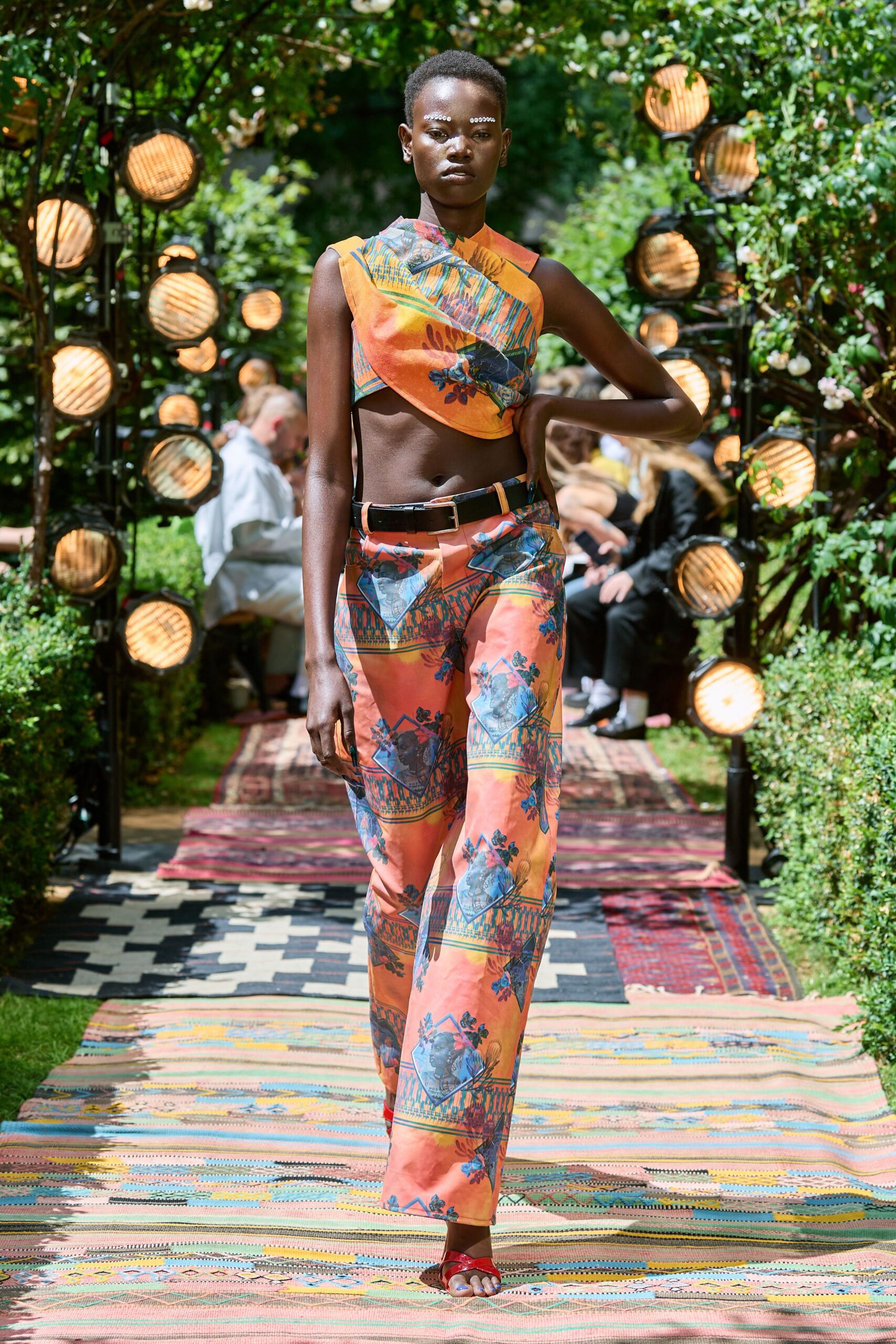 printed orange top and flared pants