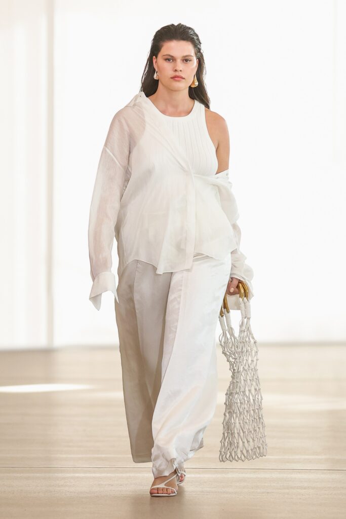 A relaxed white silk top with a long sleeve and matching pants, featuring a layered design.