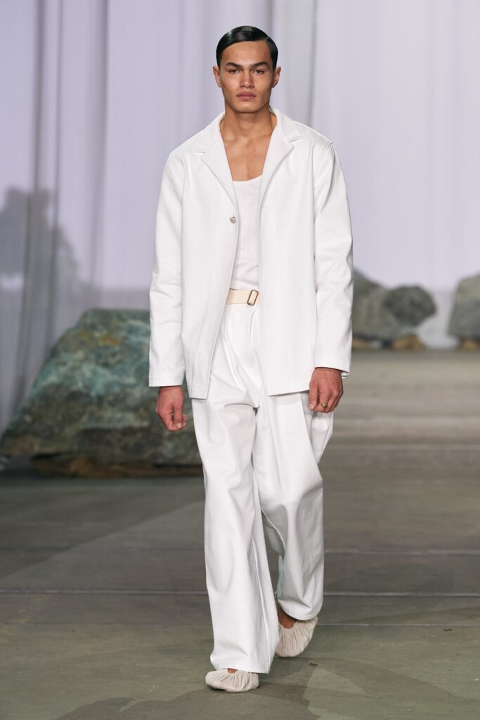 A relaxed white jacket with long sleeves and collared design paired with matching pants.