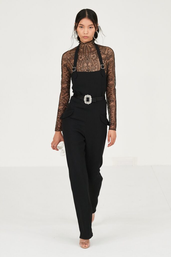 A fitted black jumpsuit with long sleeves and a straight-leg design.