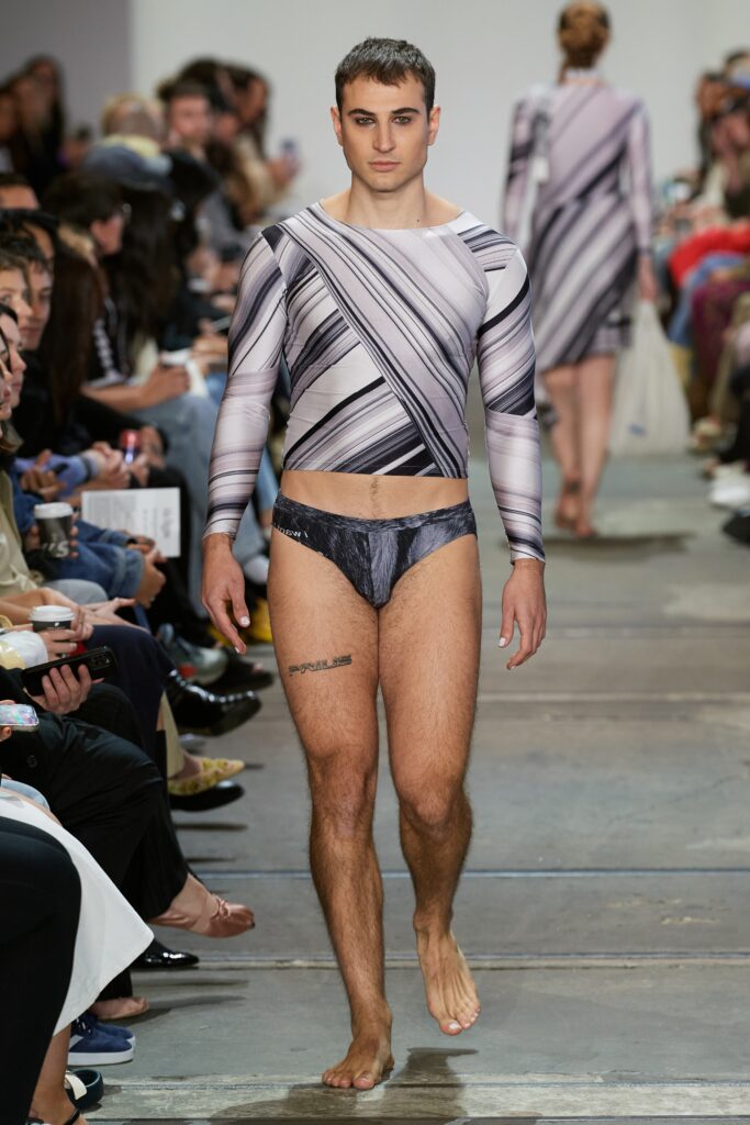 A fitted gray striped long-sleeve top paired with a black swimsuit bottom.