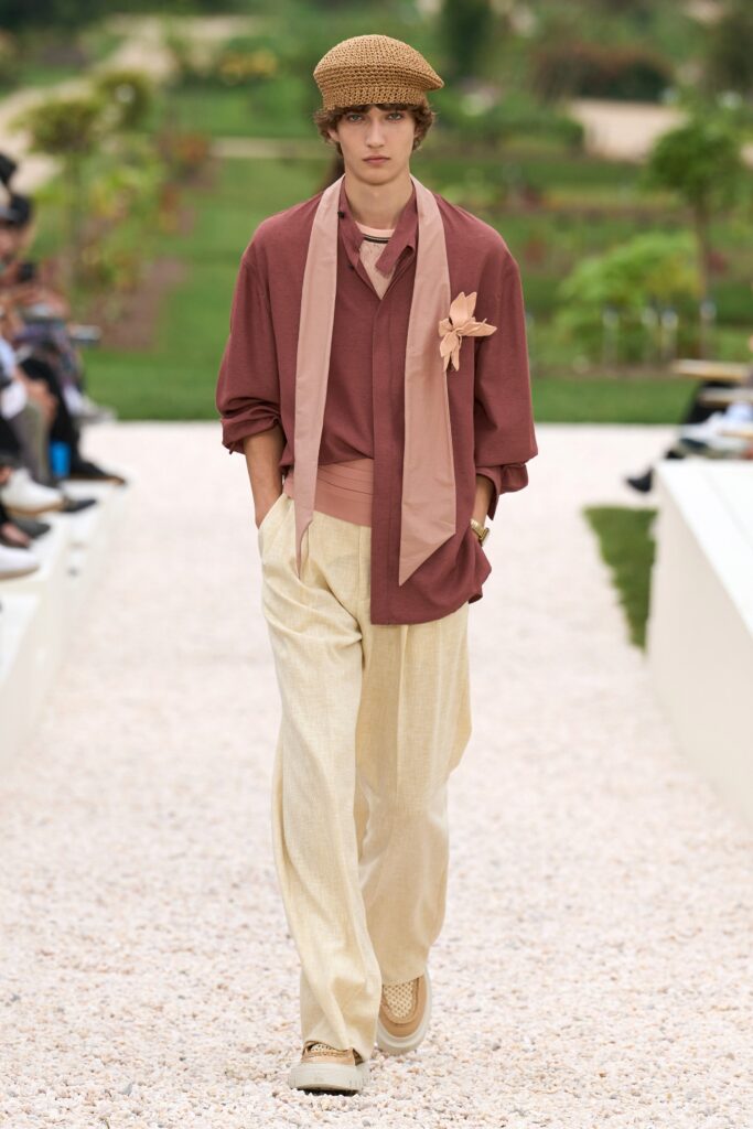 A relaxed brown cotton long-sleeve shirt layered over a beige pair of pants.