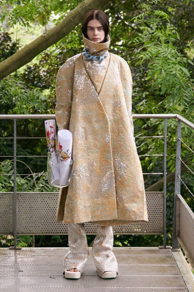 A relaxed beige sequin coat with long sleeves and a collared design, paired with matching pants.