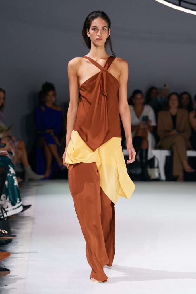 A relaxed brown and yellow sleeveless dress with a V-neckline and asymmetric design.