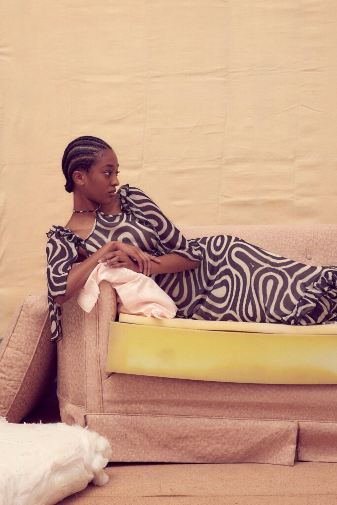 A relaxed black and white printed dress with short sleeves and a V-neckline.