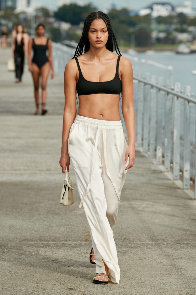 black bikini and white relaxed pants