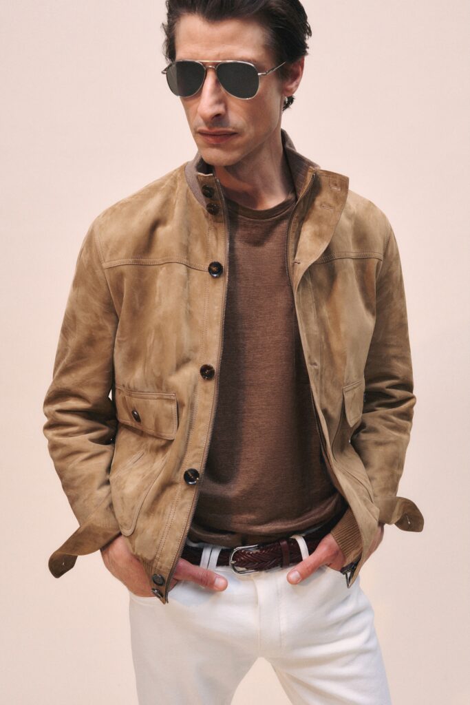 A fitted brown leather jacket paired with a collared long-sleeve shirt.