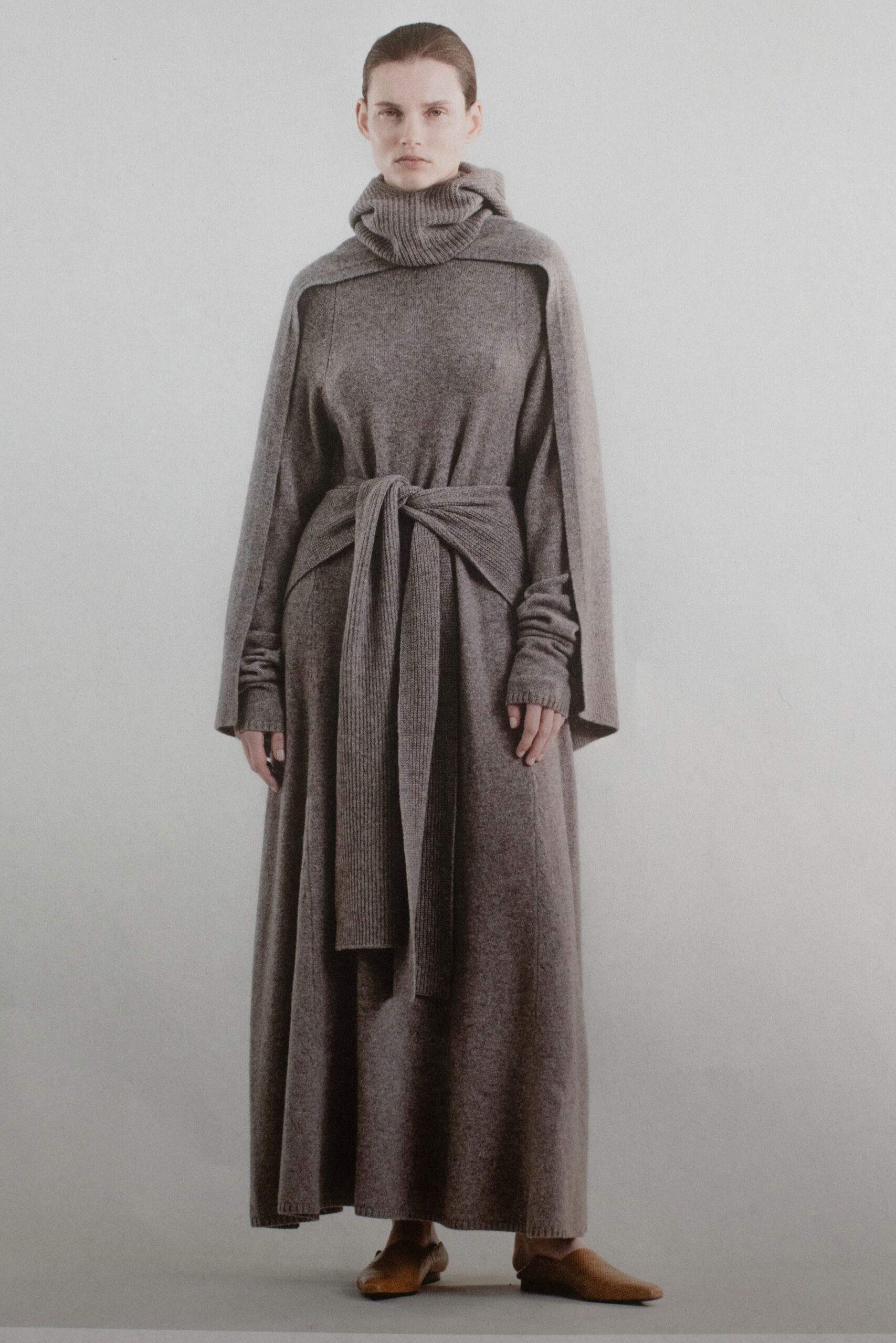 A relaxed gray wool dress with a high-neck and belted maxi silhouette.