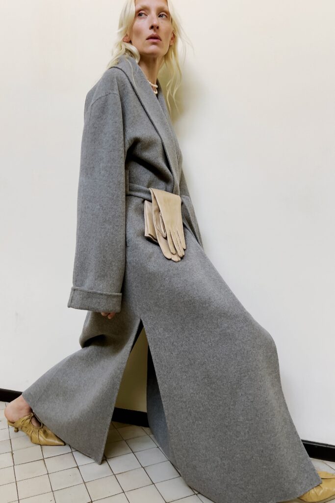 An oversized gray wool coat with long sleeves and a belted design.