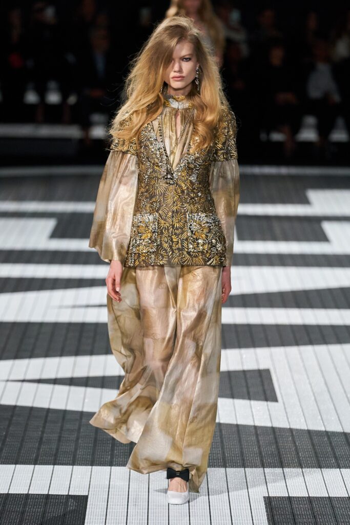 A relaxed gold and beige embroidered dress with long sleeves and a V-neckline.