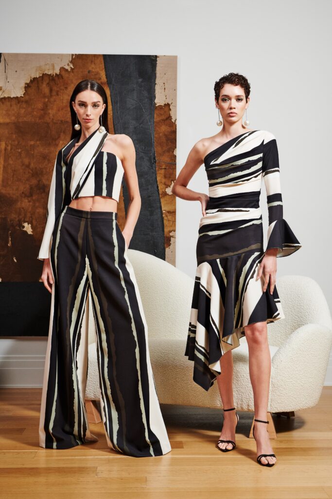 A fitted black and white striped top with long sleeves paired with matching fitted pants.