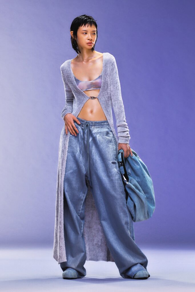 A relaxed gray cardigan with long sleeves paired with wide-leg blue pants.