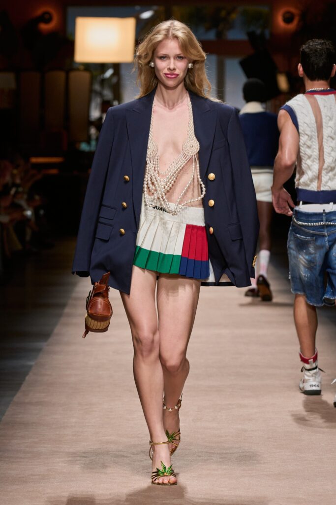 A fitted color-blocked mini skirt paired with a blue long-sleeve blazer featuring a V-neckline.