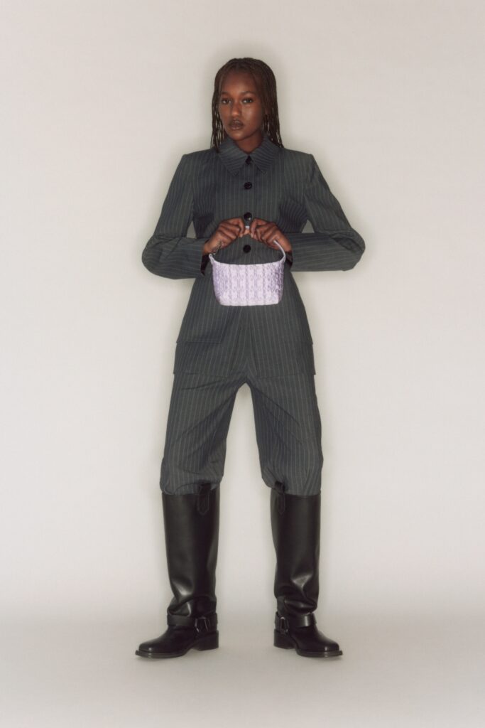 A fitted gray striped jumpsuit with long sleeves and a collared neckline.