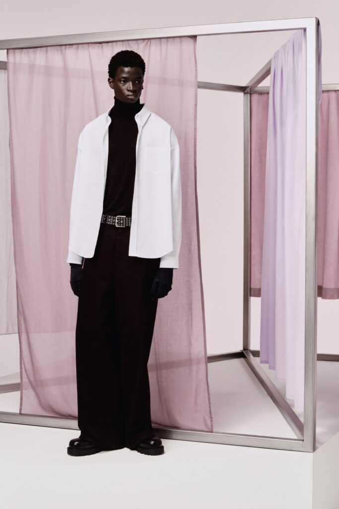 A relaxed white collared shirt paired with wide-leg black pants for a contemporary look.