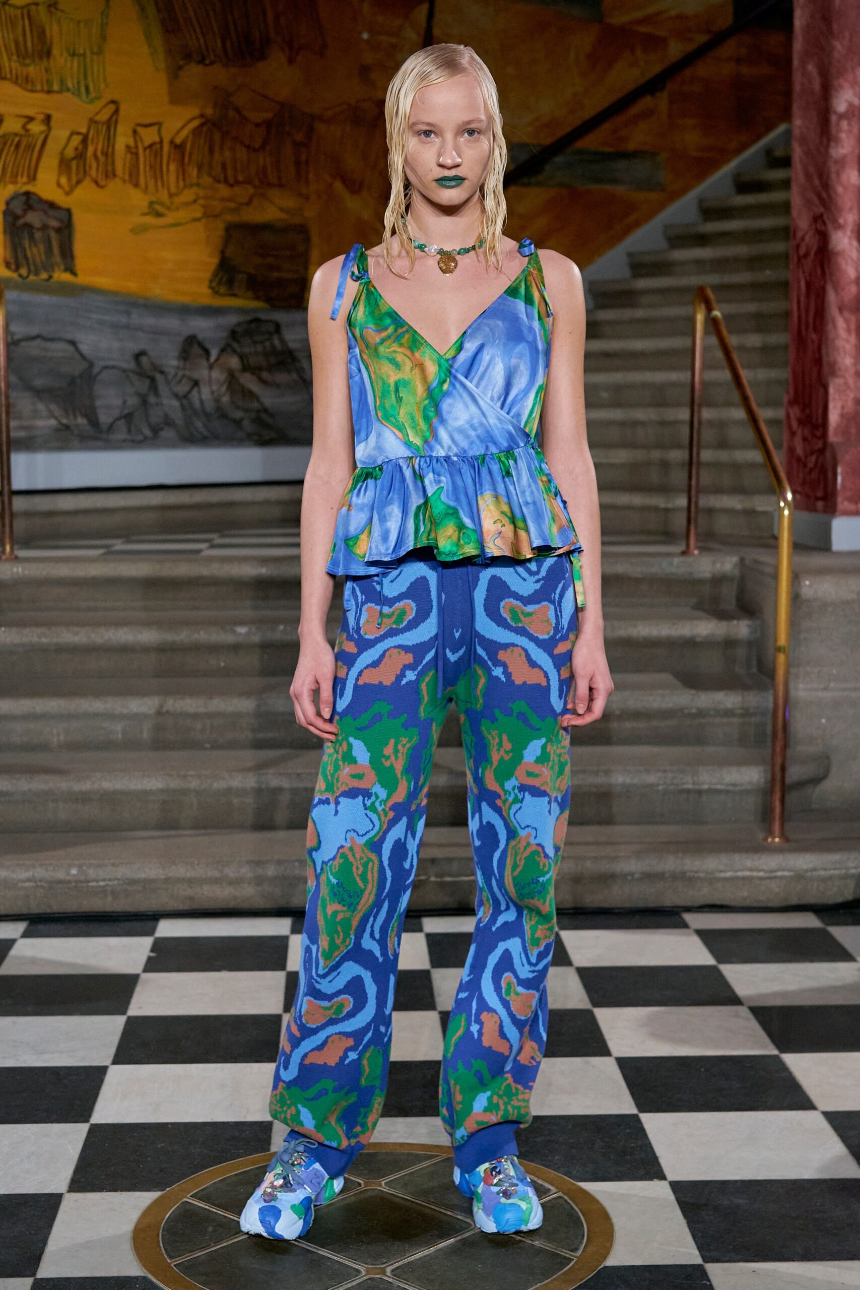 A relaxed fit sleeveless top with a V-neck and printed pants in blue and green hues.
