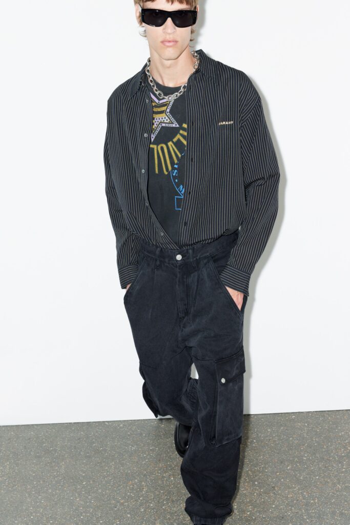 A relaxed black striped long-sleeve shirt paired with cargo pants, creating a stylish urban look.