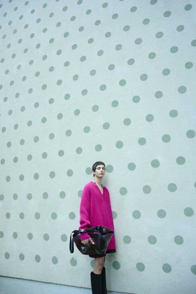 An oversized pink dress with long sleeves, perfect for a casual yet stylish look.