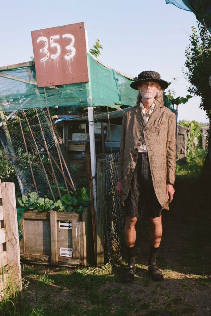 A relaxed brown cotton coat paired with shorts, featuring a long-sleeve and collared design.