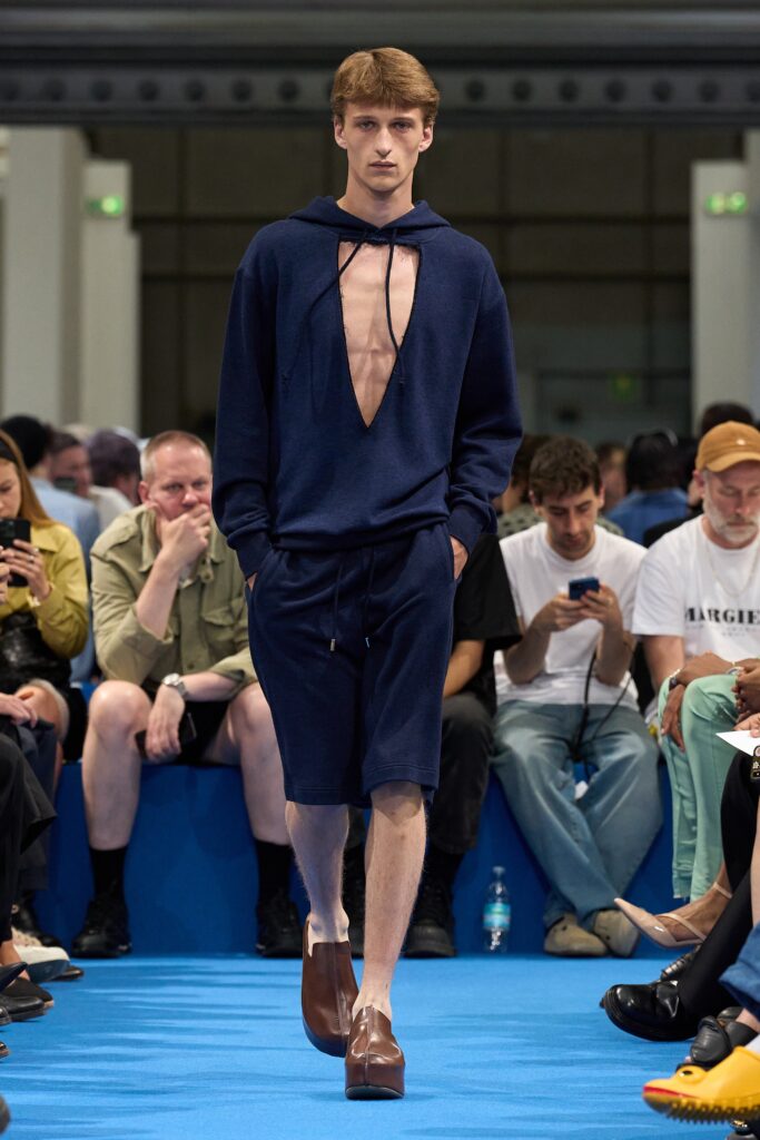 A relaxed blue cotton hoodie with a cutout design, paired with matching shorts.