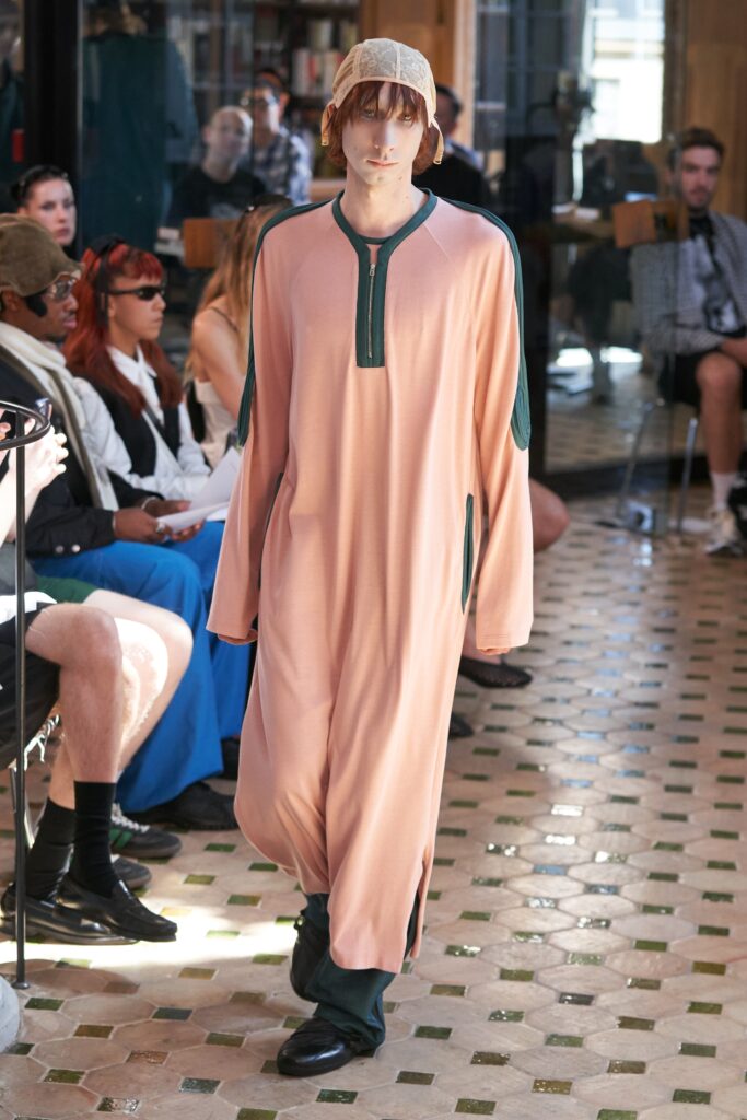 A relaxed pink long-sleeve dress with a collared neckline and straight-leg silhouette.