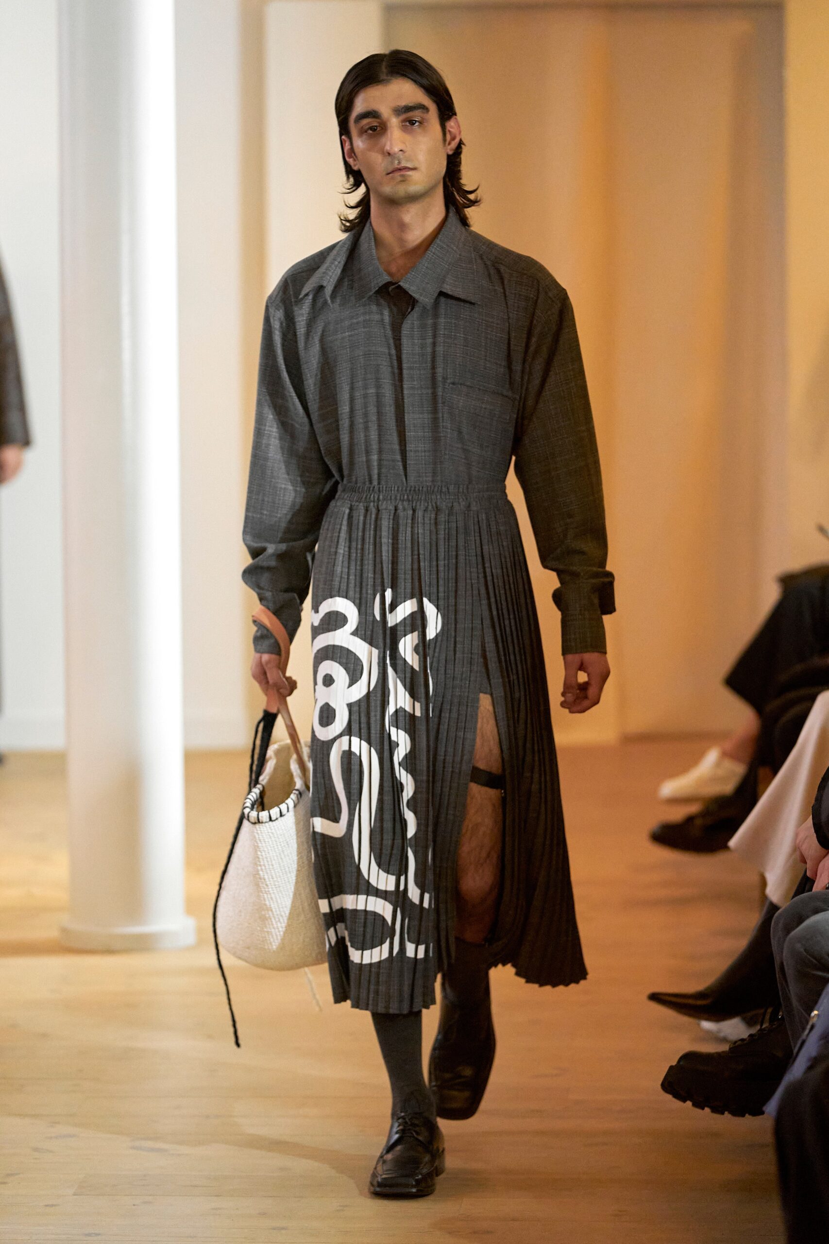 A relaxed gray cotton long-sleeve dress with a pleated design and printed details.