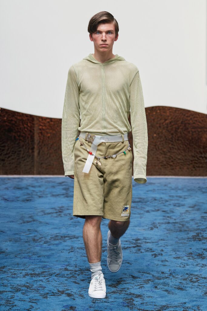 green fitted hoodie with beige shorts