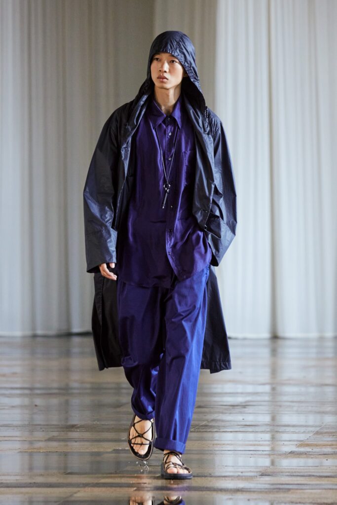 A relaxed blue coat with long sleeves and a collared shirt, paired with matching pants.