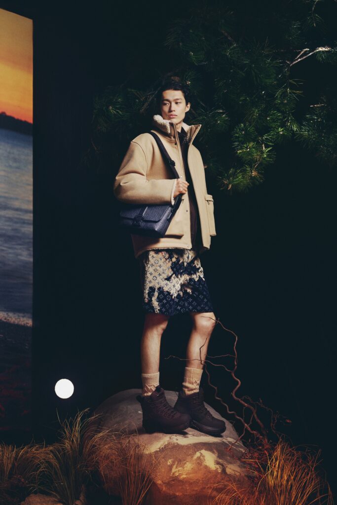 A relaxed beige jacket paired with a high-waisted blue skirt featuring an asymmetric design.