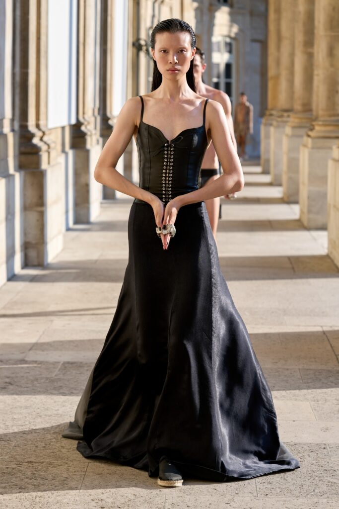 A fitted black silk dress with a sleeveless design and A-line silhouette.