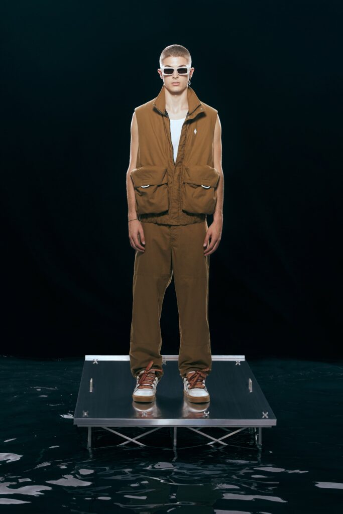 A relaxed brown cotton vest paired with matching pants featuring zippered details.