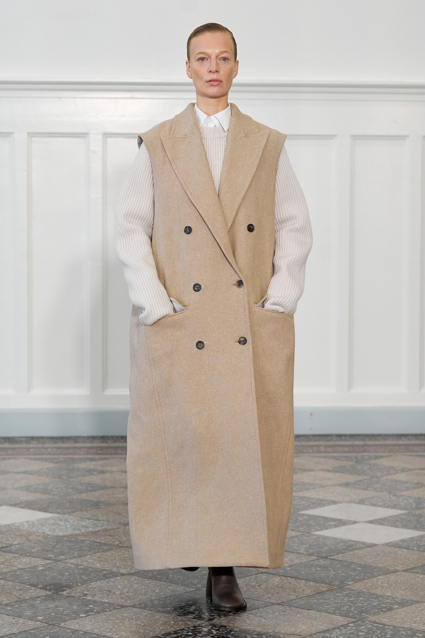 An oversized beige wool coat with long sleeves and a double-breasted design.