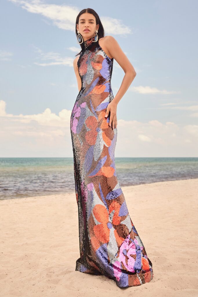 A fitted multicolor sequin sleeveless gown with a high neckline and flared silhouette.